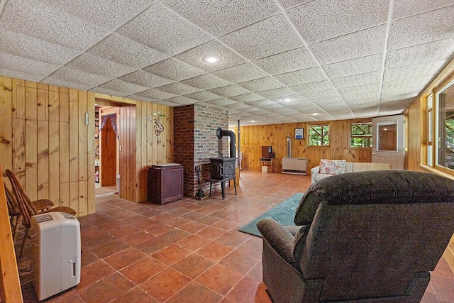 176 Perkins Beach Rd, Wayne, ME 04284 - living area with a wood stove, wood walls, recessed lighting, and tile patterned flooring