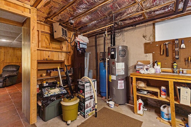 176 Perkins Beach Rd, Wayne, ME 04284 - unfinished basement featuring water heater and a water pressure tank