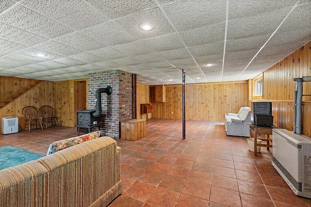 176 Perkins Beach Rd, Wayne, ME 04284 - finished basement with a wood stove, wood walls, and heating unit