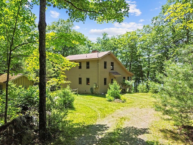 176 Perkins Beach Rd, Wayne, ME 04284 - view of side of property with a chimney and a yard