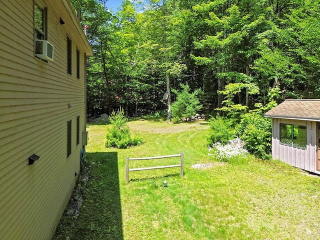 176 Perkins Beach Rd, Wayne, ME 04284 - view of grassy yard with cooling unit and an outbuilding