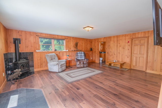 30 Hillside Dr, Kingfield, ME 04947 - sitting room featuring a wood stove, wood finished floors, and wood walls