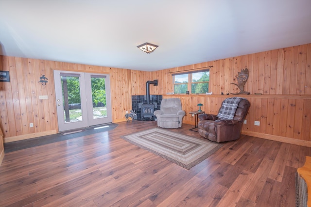 30 Hillside Dr, Kingfield, ME 04947 - living area featuring a wood stove, healthy amount of natural light, wood finished floors, and wooden walls