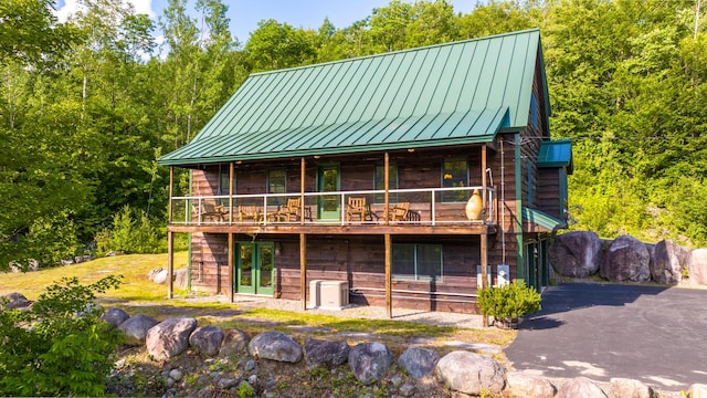 30 Hillside Dr, Kingfield, ME 04947 - view of front of house with a standing seam roof, a metal roof, and a deck