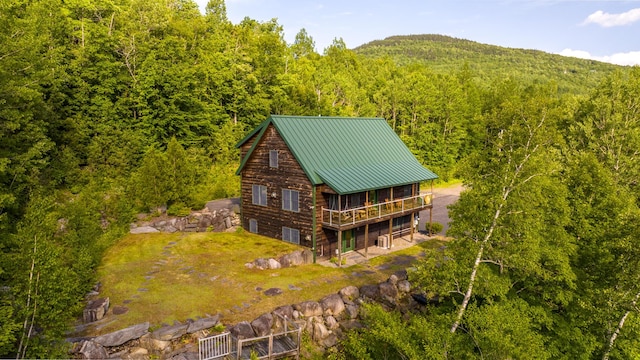 30 Hillside Dr, Kingfield, ME 04947 - rear view of property featuring a forest view, a wooden deck, and a metal roof