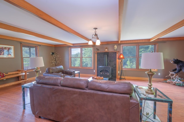 30 Hillside Dr, Kingfield, ME 04947 - living room with beam ceiling, a wood stove, and wood finished floors