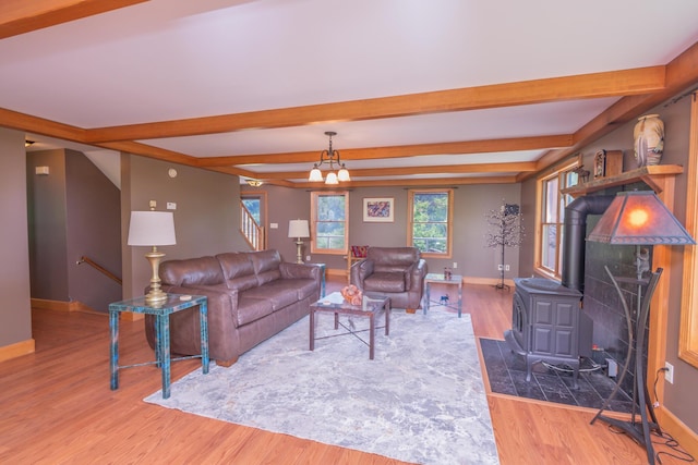 30 Hillside Dr, Kingfield, ME 04947 - living room featuring a wood stove, wood finished floors, and beamed ceiling