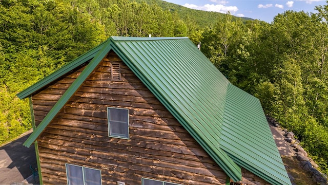 30 Hillside Dr, Kingfield, ME 04947 - view of home's exterior featuring a view of trees and a metal roof