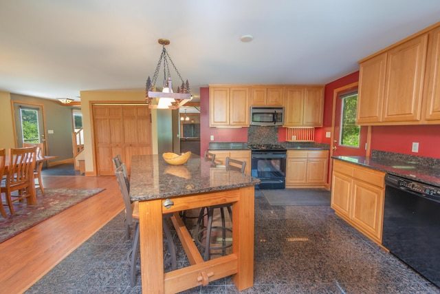 30 Hillside Dr, Kingfield, ME 04947 - kitchen with black appliances, dark stone countertops, backsplash, hanging light fixtures, and dark wood-style flooring