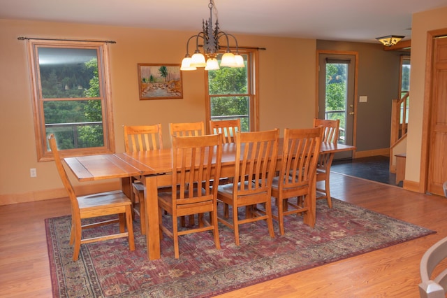 30 Hillside Dr, Kingfield, ME 04947 - dining space with plenty of natural light, a chandelier, wood finished floors, and stairway