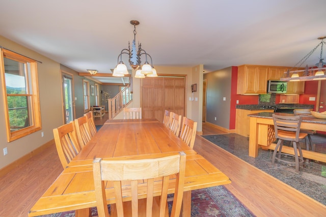 30 Hillside Dr, Kingfield, ME 04947 - dining space featuring a chandelier, light wood-style floors, and stairs