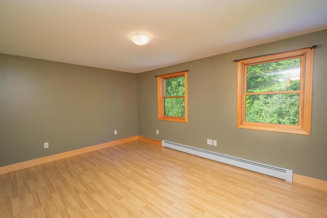 30 Hillside Dr, Kingfield, ME 04947 - empty room featuring a baseboard radiator, light wood finished floors, and healthy amount of natural light