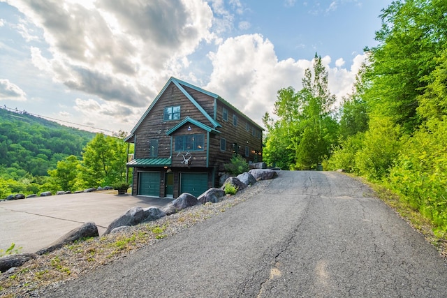 30 Hillside Dr, Kingfield, ME 04947 - view of front of house with asphalt driveway and a garage