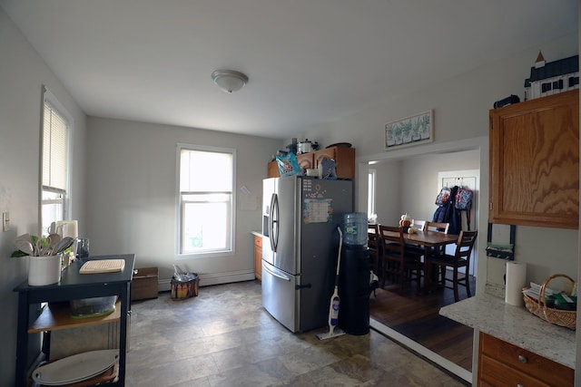 41 Dunn St, Auburn, ME 04210 - kitchen featuring stainless steel fridge, brown cabinetry, and baseboard heating
