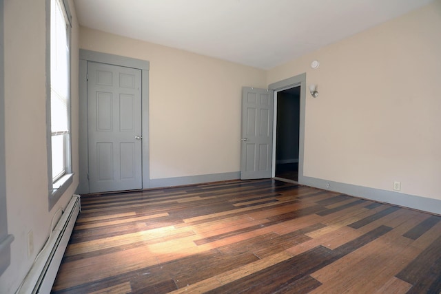 41 Dunn St, Auburn, ME 04210 - unfurnished room with a baseboard heating unit and dark wood-style flooring