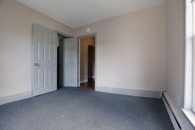 41 Dunn St, Auburn, ME 04210 - carpeted spare room featuring a baseboard heating unit and a smoke detector