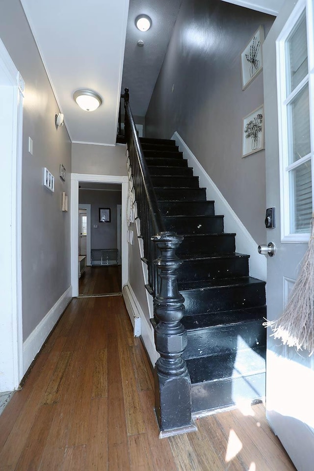41 Dunn St, Auburn, ME 04210 - stairs featuring wood finished floors and a baseboard heating unit