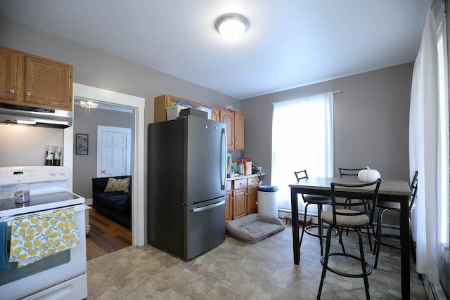 41 Dunn St, Auburn, ME 04210 - kitchen with white electric stove, freestanding refrigerator, under cabinet range hood, light countertops, and brown cabinetry