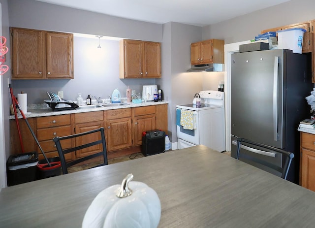 41 Dunn St, Auburn, ME 04210 - kitchen featuring electric stove, freestanding refrigerator, exhaust hood, and brown cabinetry