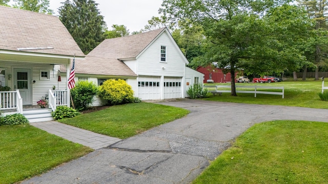 22 River Rd, Dresden, ME 04342 - view of front of house featuring a garage, a front lawn, driveway, and a porch