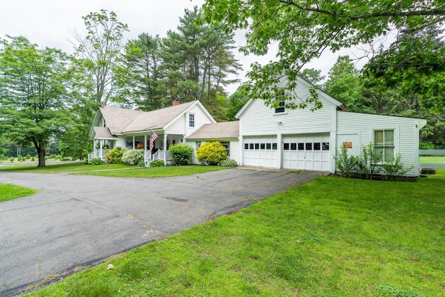 22 River Rd, Dresden, ME 04342 - view of front of home featuring asphalt driveway, a porch, and a front lawn