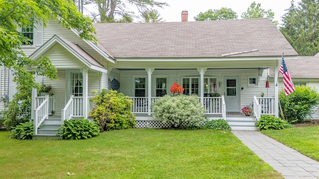 22 River Rd, Dresden, ME 04342 - bungalow-style house with covered porch, a front yard, a chimney, and roof with shingles