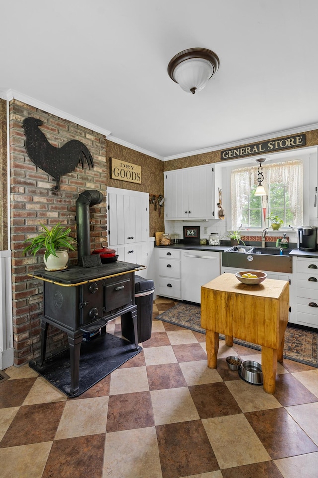 22 River Rd, Dresden, ME 04342 - kitchen with a wood stove, dishwasher, white cabinetry, and dark countertops