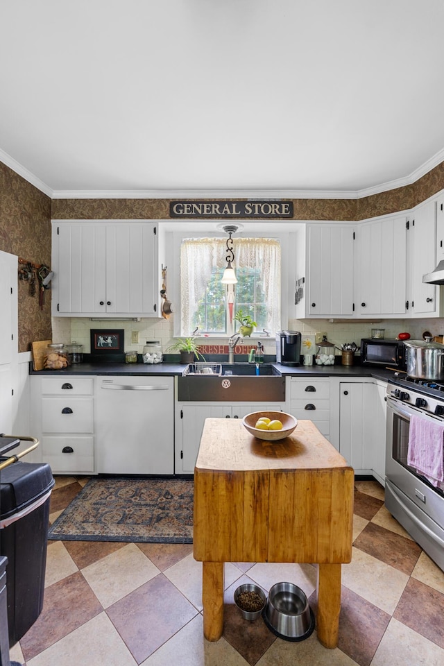 22 River Rd, Dresden, ME 04342 - kitchen featuring white dishwasher, stainless steel range, white cabinets, dark countertops, and wallpapered walls