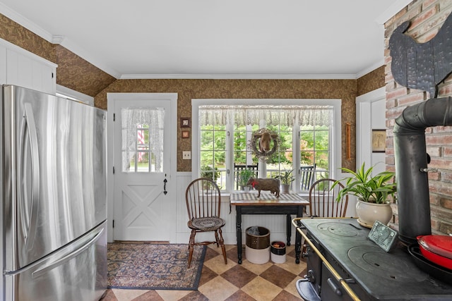 22 River Rd, Dresden, ME 04342 - dining space with a wood stove, wallpapered walls, and healthy amount of natural light
