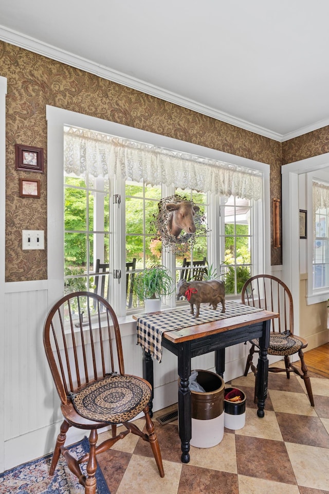 22 River Rd, Dresden, ME 04342 - dining room featuring wallpapered walls, crown molding, and a wainscoted wall