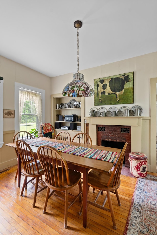 22 River Rd, Dresden, ME 04342 - dining space with wood-type flooring and a fireplace