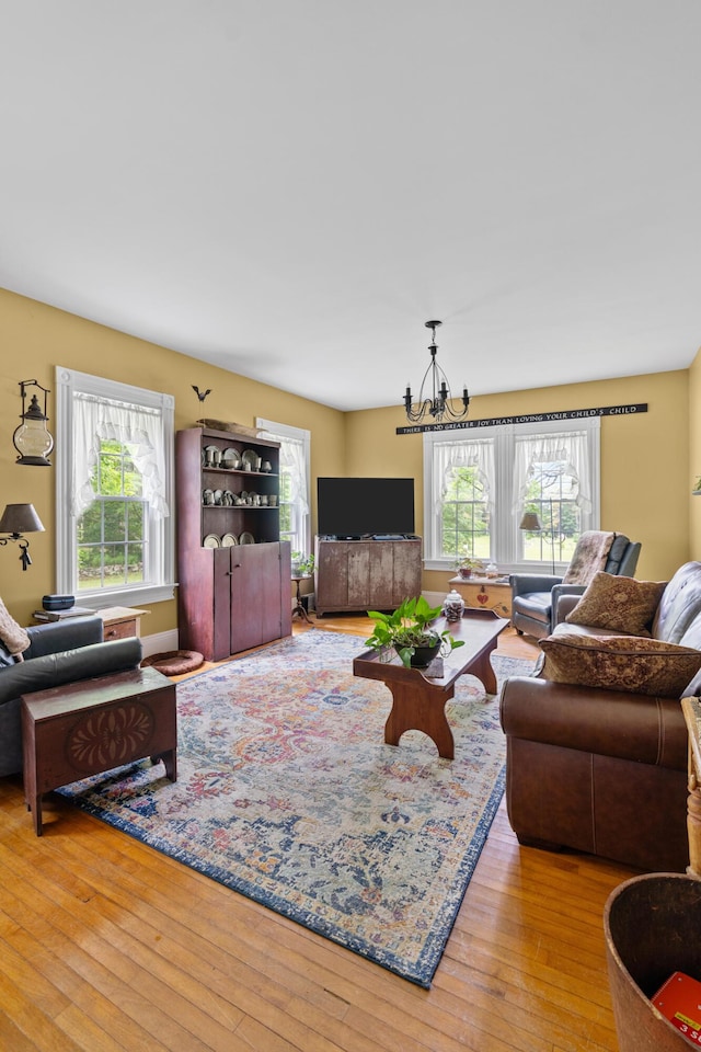 22 River Rd, Dresden, ME 04342 - living room featuring healthy amount of natural light, a chandelier, and hardwood / wood-style floors