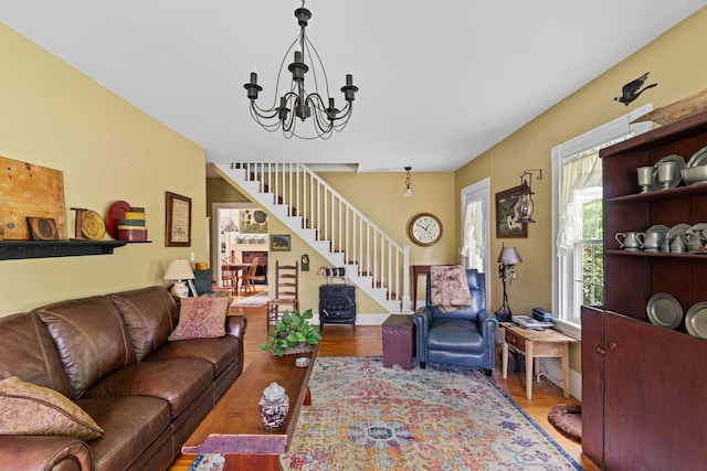 22 River Rd, Dresden, ME 04342 - living room featuring wood finished floors, stairs, and a chandelier