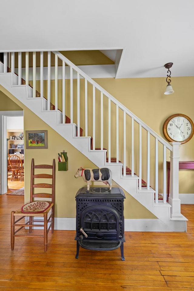 22 River Rd, Dresden, ME 04342 - stairway featuring a wood stove and wood-type flooring