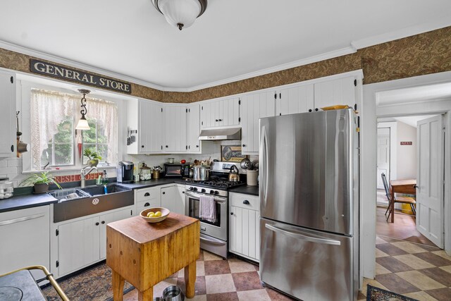 22 River Rd, Dresden, ME 04342 - kitchen featuring appliances with stainless steel finishes, under cabinet range hood, dark countertops, backsplash, and white cabinets