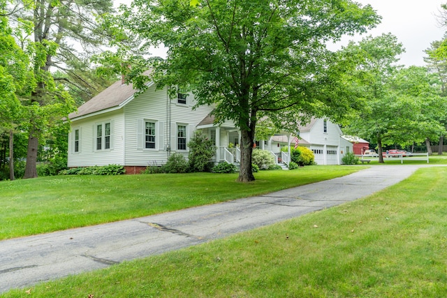 22 River Rd, Dresden, ME 04342 - view of property hidden behind natural elements with a garage, a front lawn, and asphalt driveway