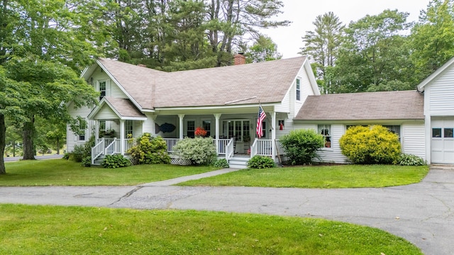 22 River Rd, Dresden, ME 04342 - view of front of house with a chimney, a front lawn, covered porch, and a shingled roof