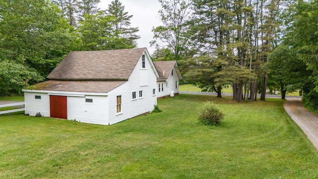 22 River Rd, Dresden, ME 04342 - view of home's exterior featuring a shingled roof, a lawn, view of scattered trees, and an outbuilding