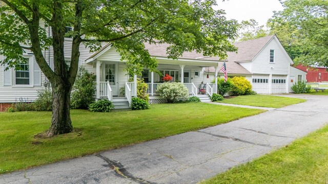 22 River Rd, Dresden, ME 04342 - view of front of house featuring covered porch, a front yard, driveway, and a shingled roof