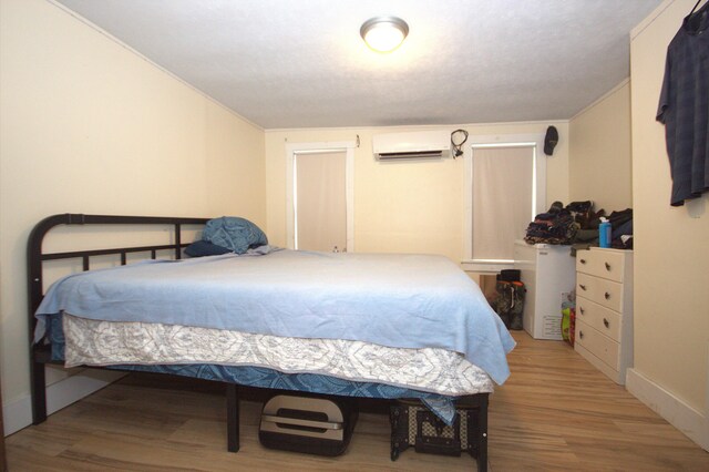 30 Burnham St, Old Town, ME 04468 - bedroom featuring a wall unit AC and wood finished floors