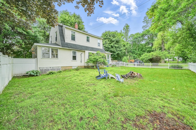2 Clark St, Randolph, ME 04346 - back of property with a chimney, a gambrel roof, a fenced backyard, and a shingled roof