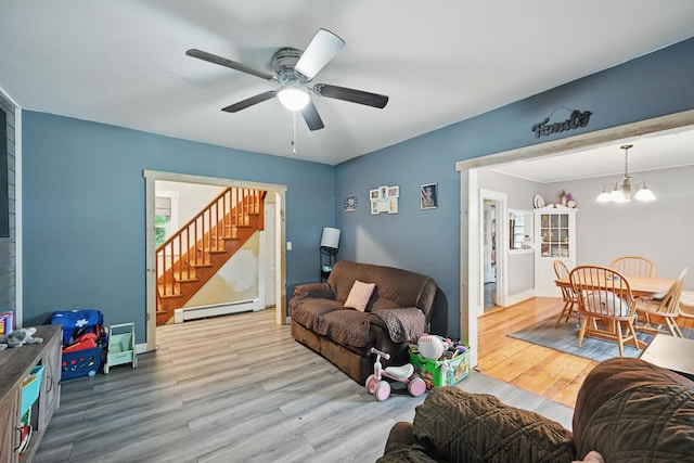 2 Clark St, Randolph, ME 04346 - living room featuring stairs, a baseboard heating unit, a ceiling fan, and wood finished floors