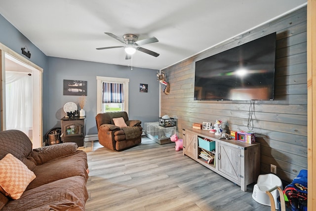 2 Clark St, Randolph, ME 04346 - living area featuring ceiling fan, wood walls, light wood-style floors, and a baseboard heating unit