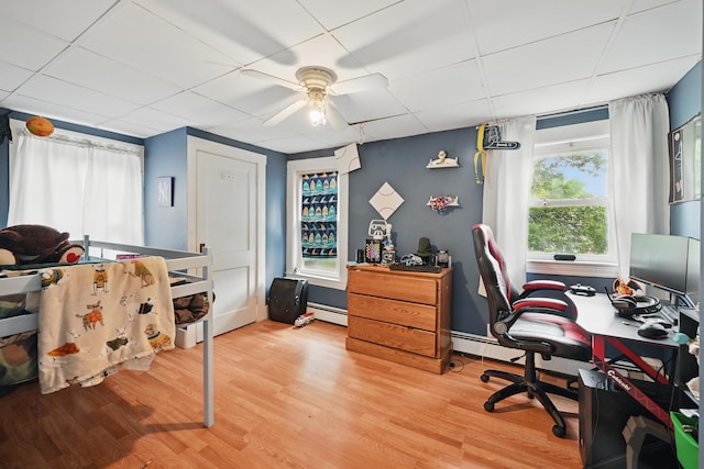 2 Clark St, Randolph, ME 04346 - office area featuring baseboard heating, light wood-style floors, a ceiling fan, and a paneled ceiling