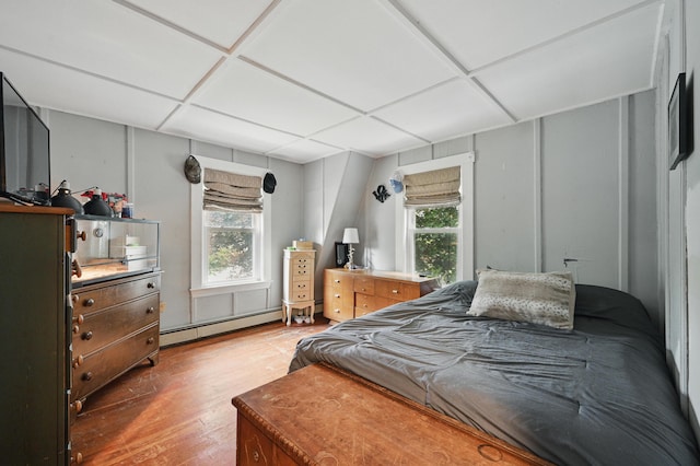 2 Clark St, Randolph, ME 04346 - bedroom featuring baseboard heating, light wood-style floors, and multiple windows