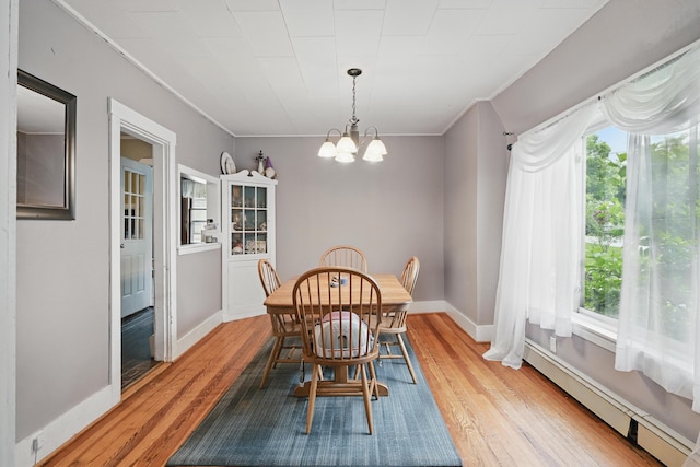 2 Clark St, Randolph, ME 04346 - dining area with a chandelier, a baseboard radiator, light wood-style floors, and crown molding
