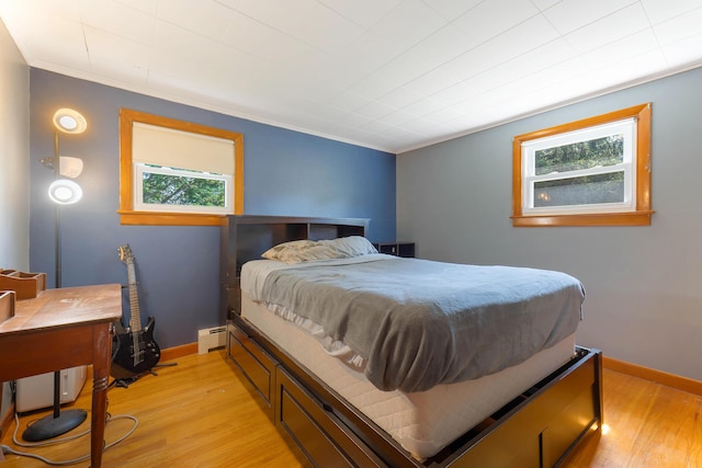 911 Spring St, Westbrook, ME 04092 - bedroom featuring a baseboard radiator, light wood-style floors, and ornamental molding