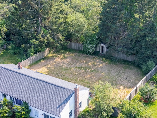 911 Spring St, Westbrook, ME 04092 - fenced backyard with a storage shed and a wooded view