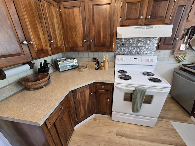 314 River Rd, Orrington, ME 04474 - kitchen with white range with electric stovetop, under cabinet range hood, backsplash, and light wood finished floors