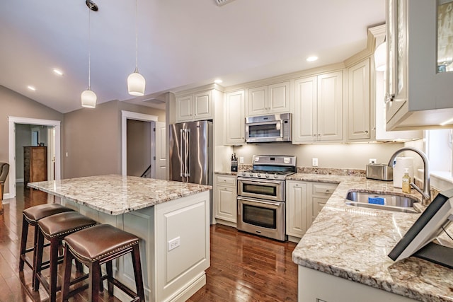 375 Pride St Unit 15, Westbrook, ME 04092 - kitchen featuring appliances with stainless steel finishes, dark wood-style flooring, light stone countertops, recessed lighting, and a kitchen island